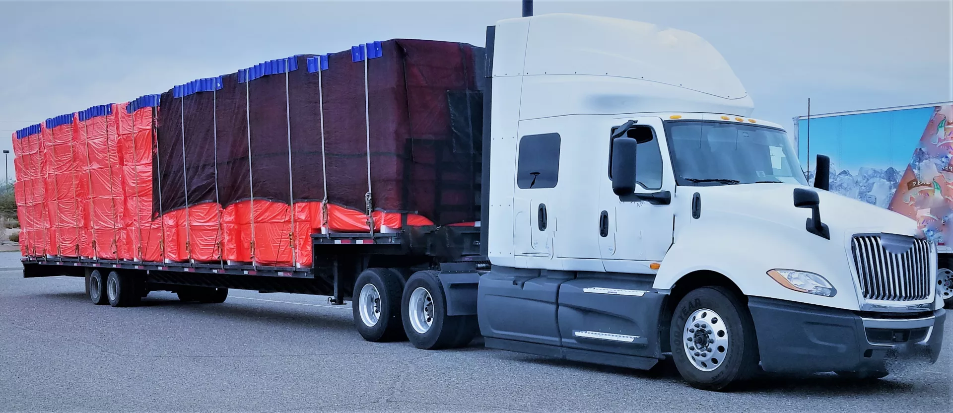 White International semi-truck with covered cargo load