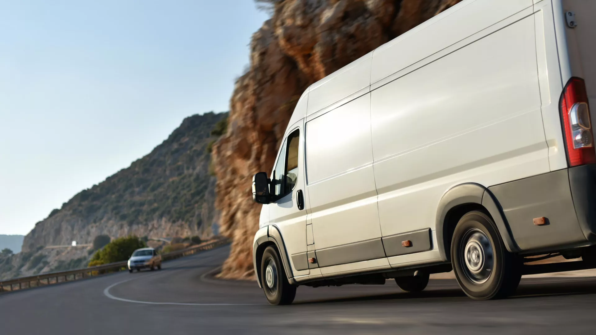 White delivery van on scenic mountain road