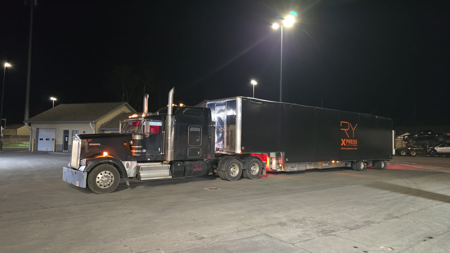Black RY29 Kenworth with RyXpress enclosed trailer at night