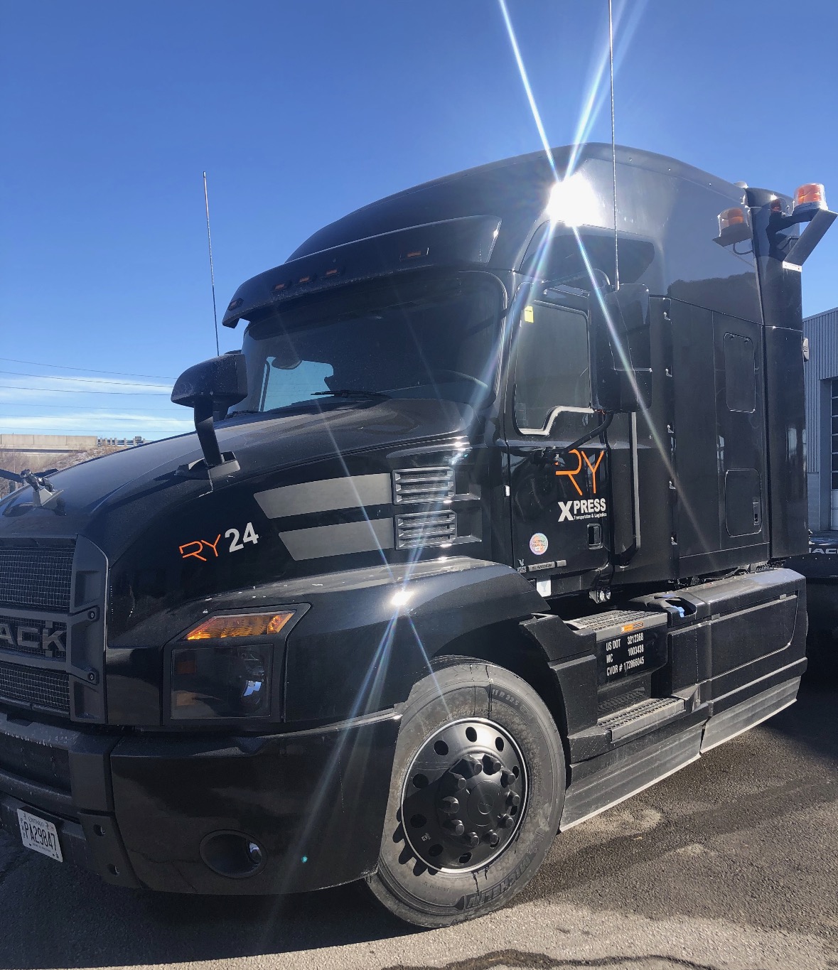 Black RY24 Mack truck with sun flare and RyXpress branding