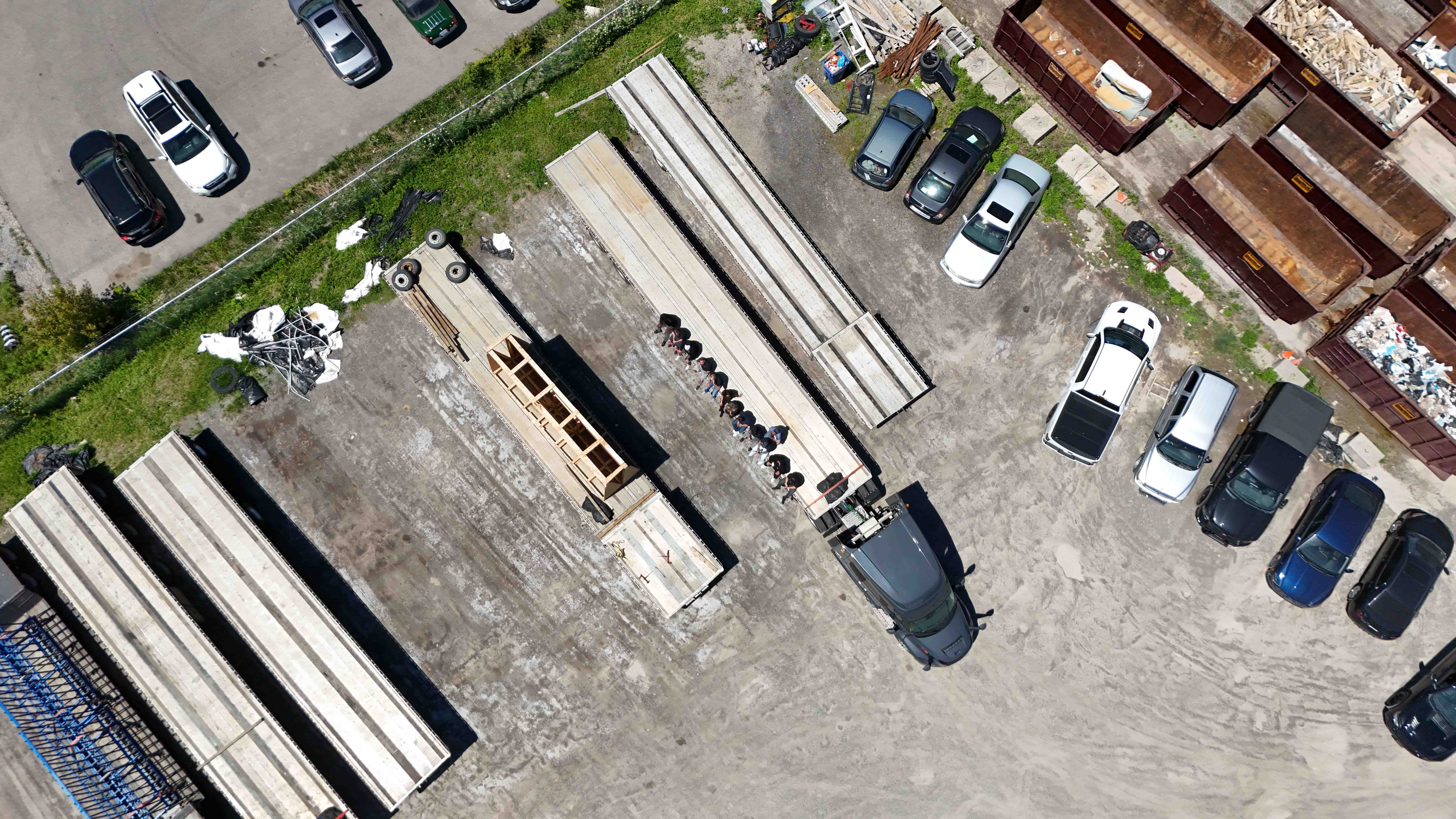 Top-down aerial of the RY Xpress yard with flatbed trailers, fleet, and team
