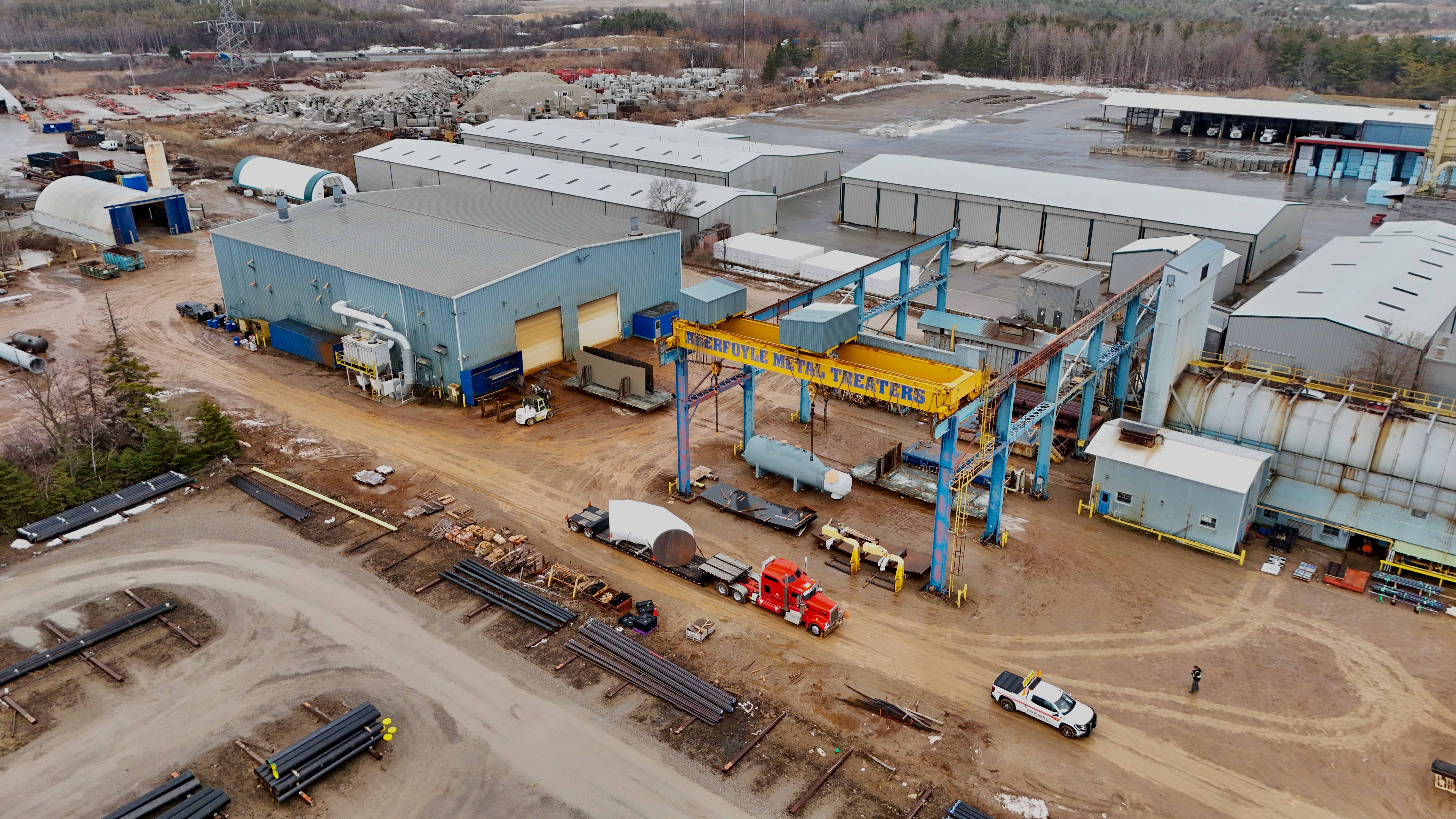 Wide aerial view of industrial facility with gantry crane and RY truck